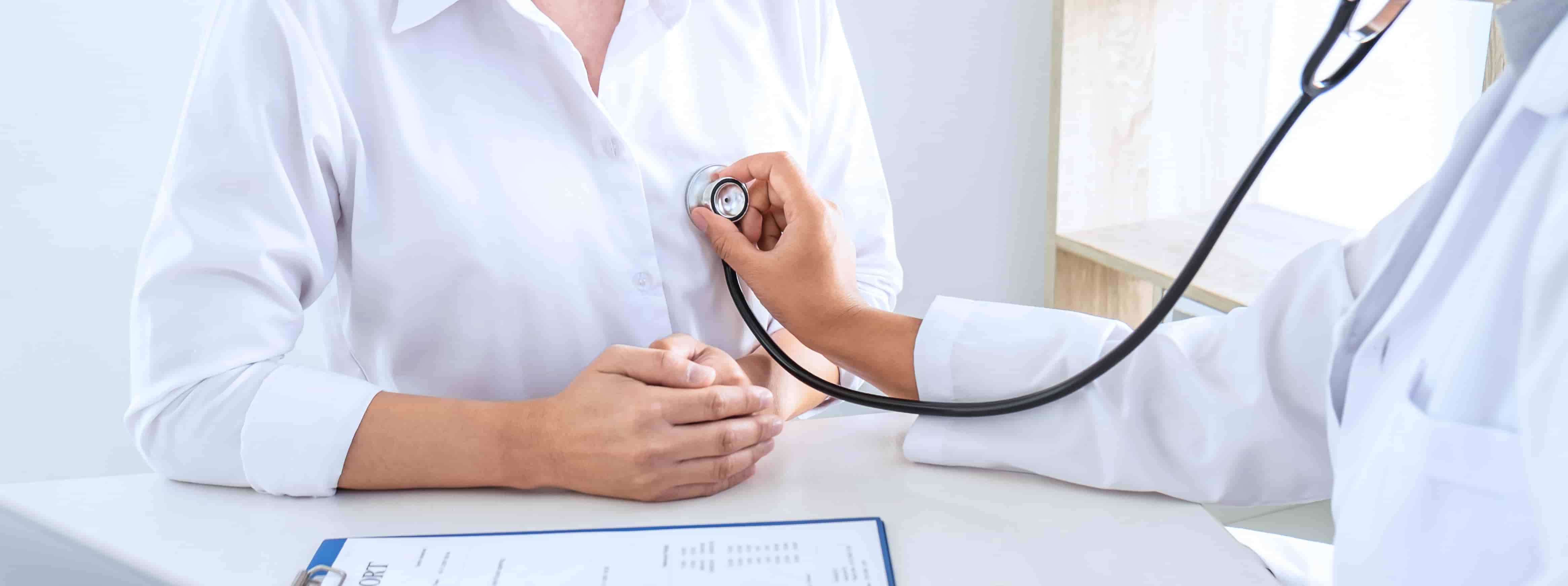 Doctor using a stethoscope checking patient cardio