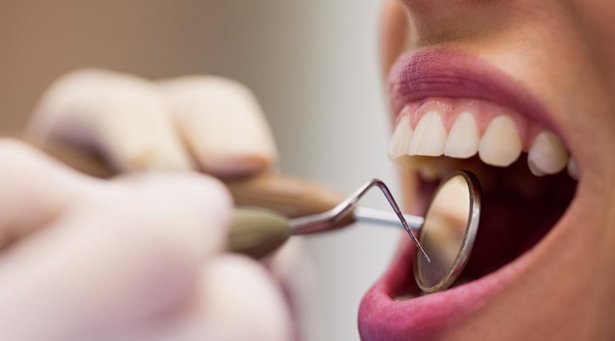 dentist-examining-a-female-patient-with-tools
